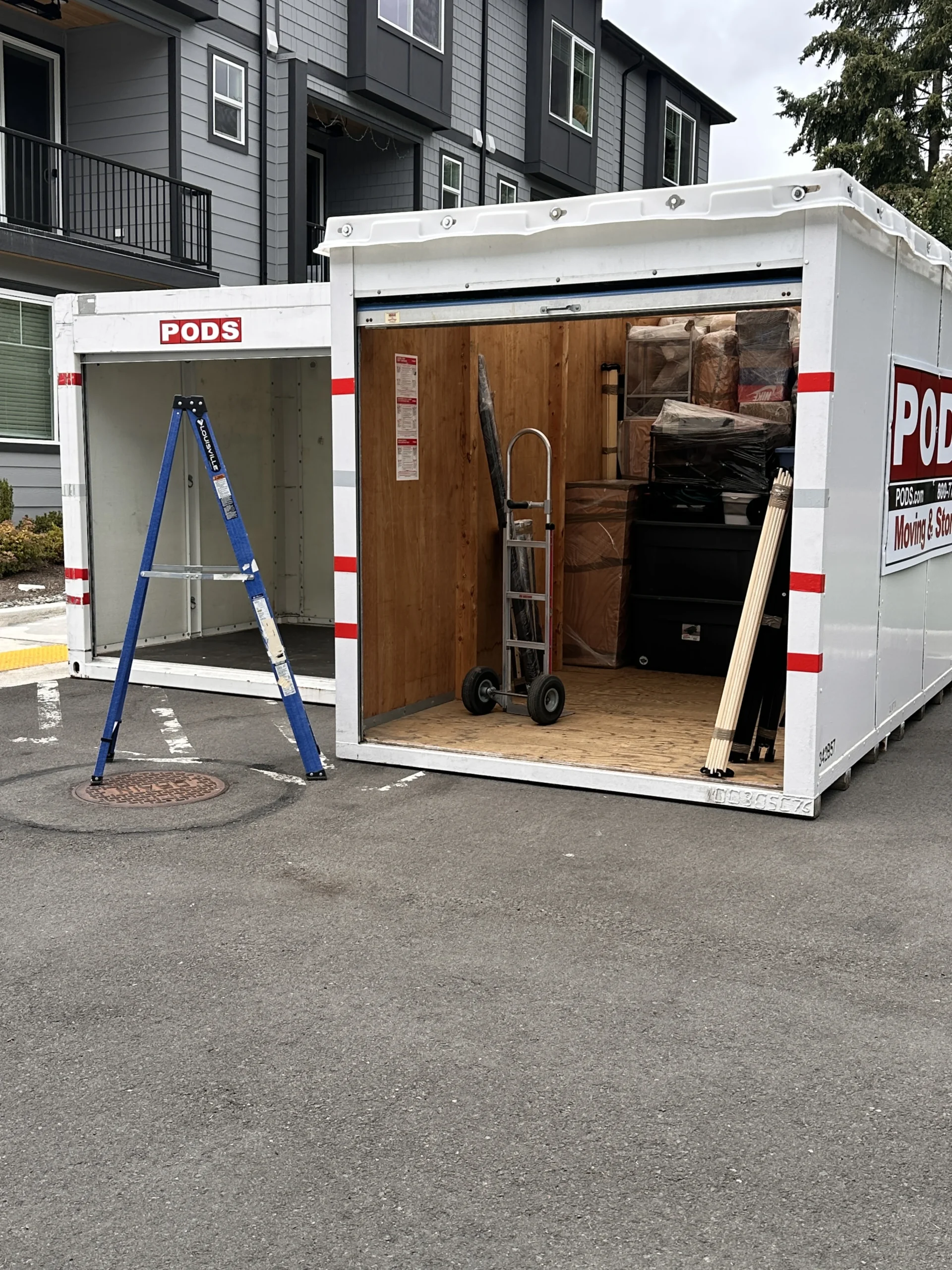 Services 3 Professional movers loading a POD storage container